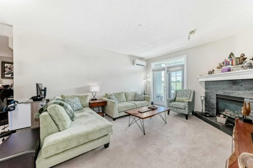210-1005A Westmount Drive, Strathmore, AB - Indoor Photo Showing Living Room With Fireplace