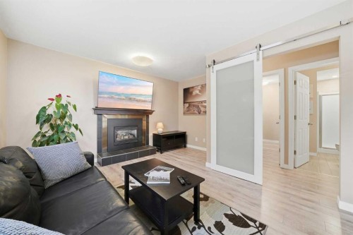 132 Shawcliffe Circle Sw, Calgary, AB - Indoor Photo Showing Living Room With Fireplace