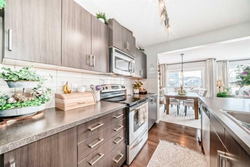 117 Sunset Common, Cochrane, AB - Indoor Photo Showing Kitchen With Stainless Steel Kitchen With Upgraded Kitchen