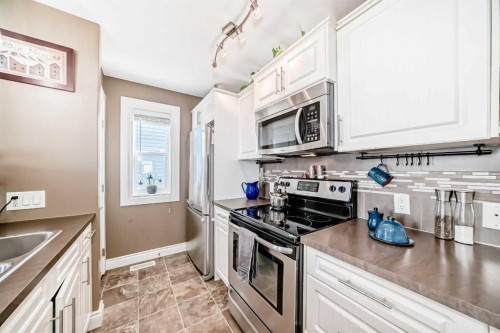 20 Mackenzie, Carstairs, AB - Indoor Photo Showing Kitchen With Stainless Steel Kitchen