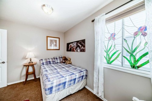 20 Mackenzie, Carstairs, AB - Indoor Photo Showing Bedroom