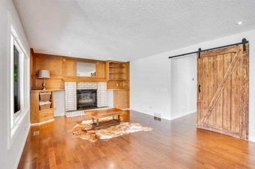 73 Riverview Close Se, Calgary, AB - Indoor Photo Showing Living Room With Fireplace