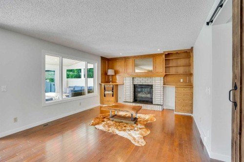 73 Riverview Close Se, Calgary, AB - Indoor Photo Showing Living Room With Fireplace