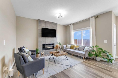 521 Corner Meadows Way Ne, Calgary, AB - Indoor Photo Showing Living Room With Fireplace