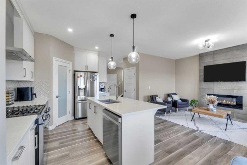 521 Corner Meadows Way Ne, Calgary, AB - Indoor Photo Showing Kitchen With Fireplace With Stainless Steel Kitchen With Double Sink With Upgraded Kitchen