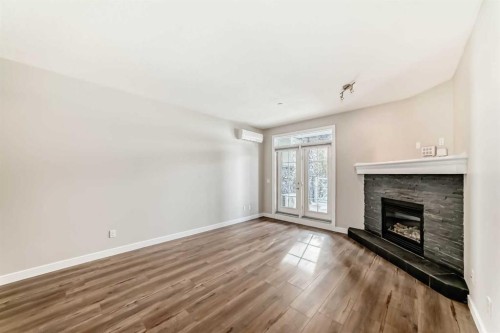 110-1005A Westmount Drive, Strathmore, AB - Indoor Photo Showing Living Room With Fireplace