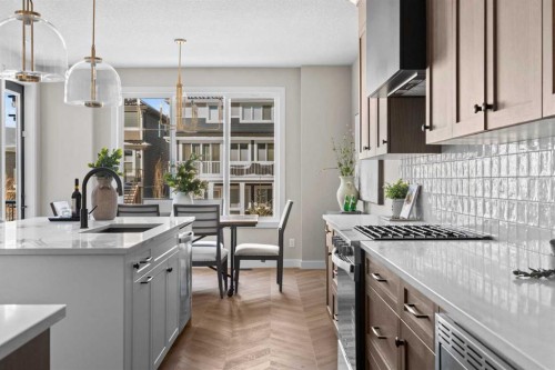 47 Sundown Crescent, Cochrane, AB - Indoor Photo Showing Kitchen With Upgraded Kitchen
