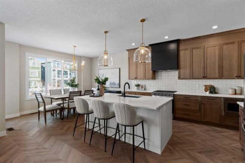 47 Sundown Crescent, Cochrane, AB - Indoor Photo Showing Kitchen With Upgraded Kitchen