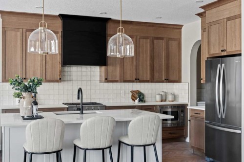 47 Sundown Crescent, Cochrane, AB - Indoor Photo Showing Kitchen With Upgraded Kitchen