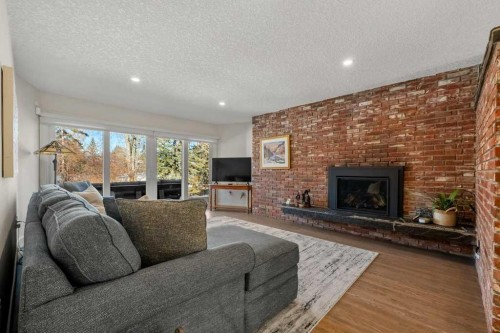 456 Wilderness Drive Se, Calgary, AB - Indoor Photo Showing Living Room With Fireplace