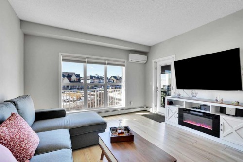 208-402 Marquis Lane Se, Calgary, AB - Indoor Photo Showing Living Room