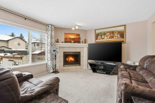 75 Somerset Manor Sw, Calgary, AB - Indoor Photo Showing Living Room With Fireplace