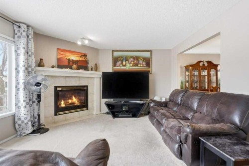 75 Somerset Manor Sw, Calgary, AB - Indoor Photo Showing Living Room With Fireplace