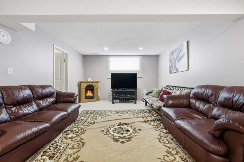 75 Somerset Manor Sw, Calgary, AB - Indoor Photo Showing Living Room With Fireplace