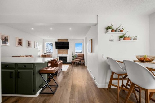 55 Coach Gate Way Sw, Calgary, AB - Indoor Photo Showing Dining Room With Fireplace