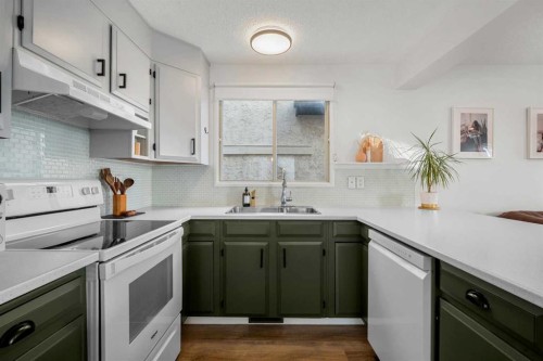 55 Coach Gate Way Sw, Calgary, AB - Indoor Photo Showing Kitchen With Double Sink