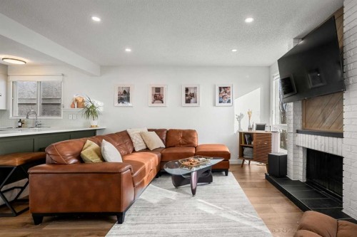 55 Coach Gate Way Sw, Calgary, AB - Indoor Photo Showing Living Room With Fireplace