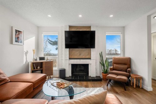55 Coach Gate Way Sw, Calgary, AB - Indoor Photo Showing Living Room With Fireplace