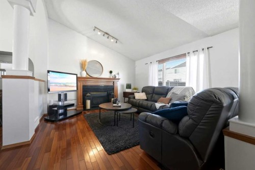 263 Coral Keys Drive Ne, Calgary, AB - Indoor Photo Showing Living Room With Fireplace