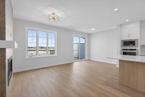 159 Greenwich Drive Nw, Calgary, AB - Indoor Photo Showing Kitchen With Fireplace