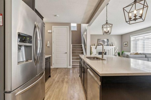 21 Riviera Point, Cochrane, AB - Indoor Photo Showing Kitchen With Double Sink