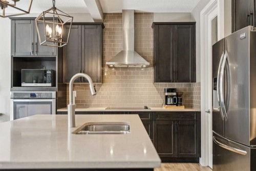 21 Riviera Point, Cochrane, AB - Indoor Photo Showing Kitchen With Double Sink With Upgraded Kitchen