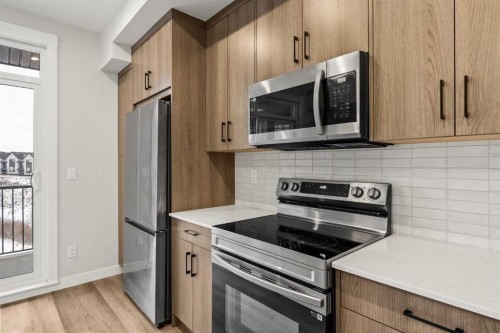 402-50 Sage Hill Nw, Calgary, AB - Indoor Photo Showing Kitchen With Stainless Steel Kitchen