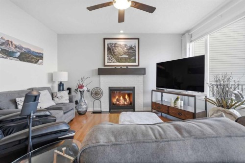238 Sunset View, Cochrane, AB - Indoor Photo Showing Living Room With Fireplace