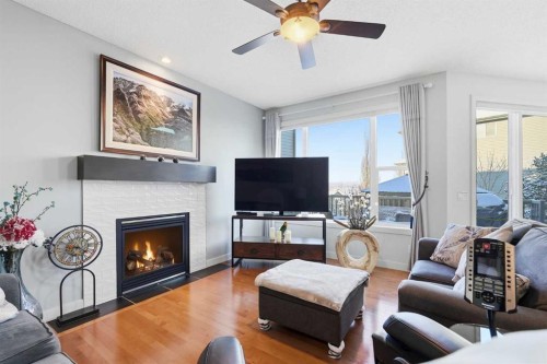238 Sunset View, Cochrane, AB - Indoor Photo Showing Living Room With Fireplace