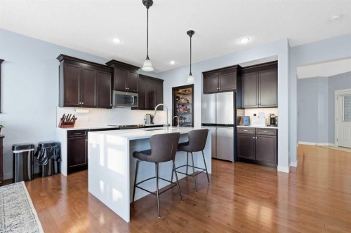 238 Sunset View, Cochrane, AB - Indoor Photo Showing Kitchen With Upgraded Kitchen