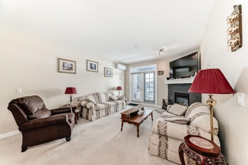 107-1005A Westmount Drive, Strathmore, AB - Indoor Photo Showing Living Room With Fireplace