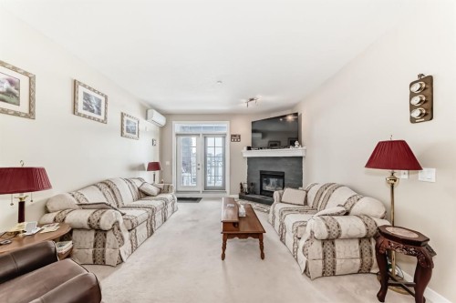 107-1005A Westmount Drive, Strathmore, AB - Indoor Photo Showing Living Room With Fireplace