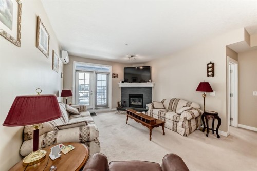 107-1005A Westmount Drive, Strathmore, AB - Indoor Photo Showing Living Room With Fireplace