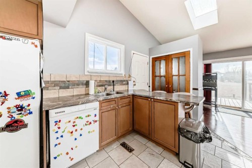 3 Cochrane Lake Trail, Cochrane Lake, AB - Indoor Photo Showing Kitchen With Double Sink