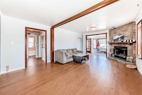 3 Cochrane Lake Trail, Cochrane Lake, AB - Indoor Photo Showing Living Room With Fireplace