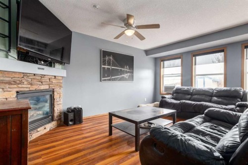 191 Panamount Heights Nw, Calgary, AB - Indoor Photo Showing Living Room With Fireplace