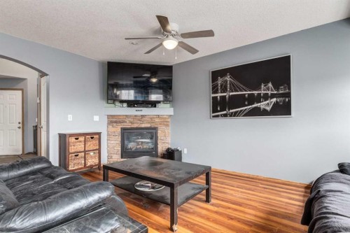 191 Panamount Heights Nw, Calgary, AB - Indoor Photo Showing Living Room With Fireplace