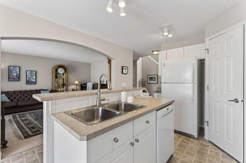 10 Cougar Ridge Bay Sw, Calgary, AB - Indoor Photo Showing Kitchen With Double Sink
