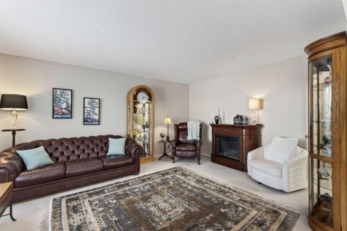 10 Cougar Ridge Bay Sw, Calgary, AB - Indoor Photo Showing Living Room With Fireplace