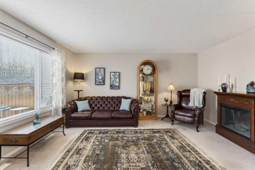 10 Cougar Ridge Bay Sw, Calgary, AB - Indoor Photo Showing Living Room With Fireplace