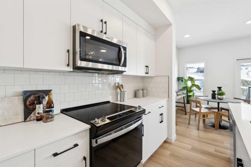 23 Heritage Heath, Cochrane, AB - Indoor Photo Showing Kitchen With Upgraded Kitchen