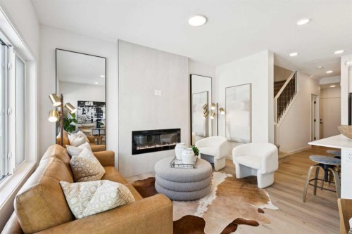 23 Heritage Heath, Cochrane, AB - Indoor Photo Showing Living Room With Fireplace