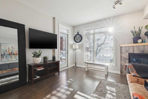 214-2 Hemlock Crescent Sw, Calgary, AB - Indoor Photo Showing Living Room With Fireplace