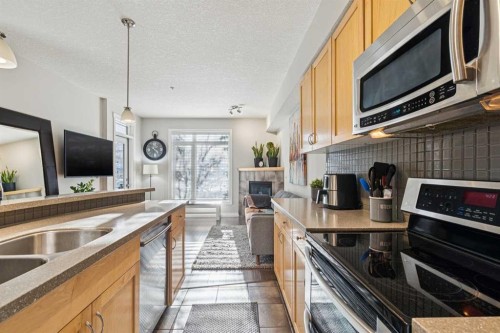 214-2 Hemlock Crescent Sw, Calgary, AB - Indoor Photo Showing Kitchen With Double Sink