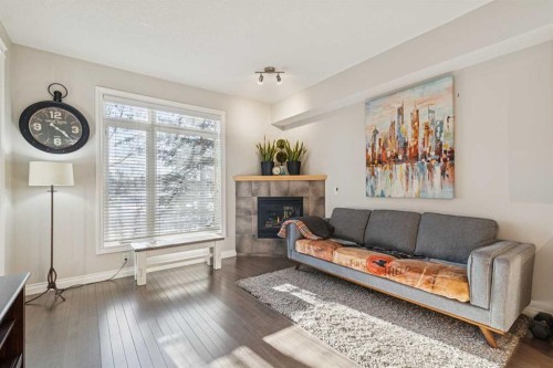 214-2 Hemlock Crescent Sw, Calgary, AB - Indoor Photo Showing Living Room With Fireplace