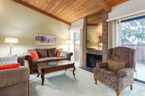 59-10030 Oakmoor Way Sw, Calgary, AB - Indoor Photo Showing Living Room With Fireplace