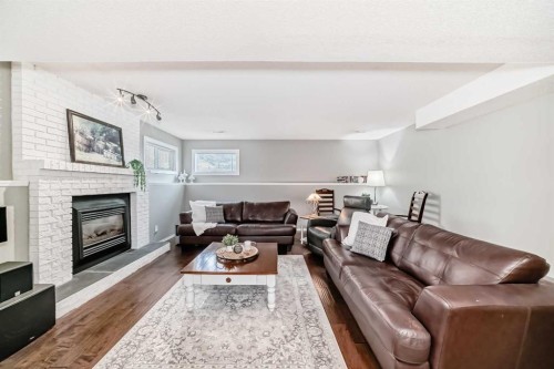 76 Riverside Way Se, Calgary, AB - Indoor Photo Showing Living Room With Fireplace