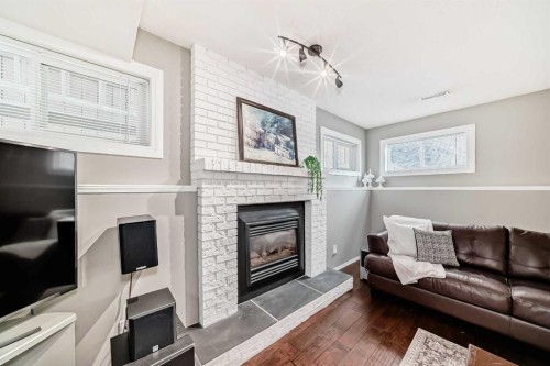 76 Riverside Way Se, Calgary, AB - Indoor Photo Showing Living Room With Fireplace