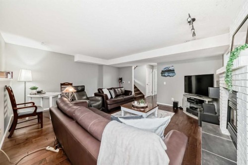 76 Riverside Way Se, Calgary, AB - Indoor Photo Showing Living Room With Fireplace