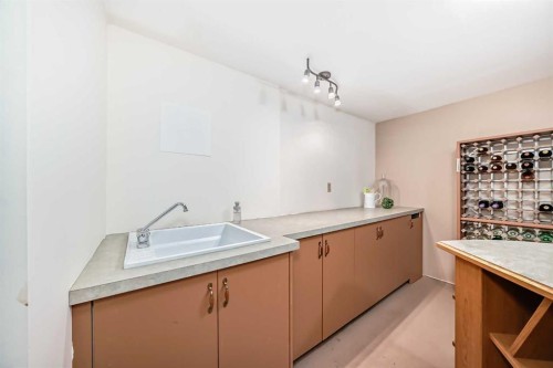 76 Riverside Way Se, Calgary, AB - Indoor Photo Showing Kitchen With Double Sink
